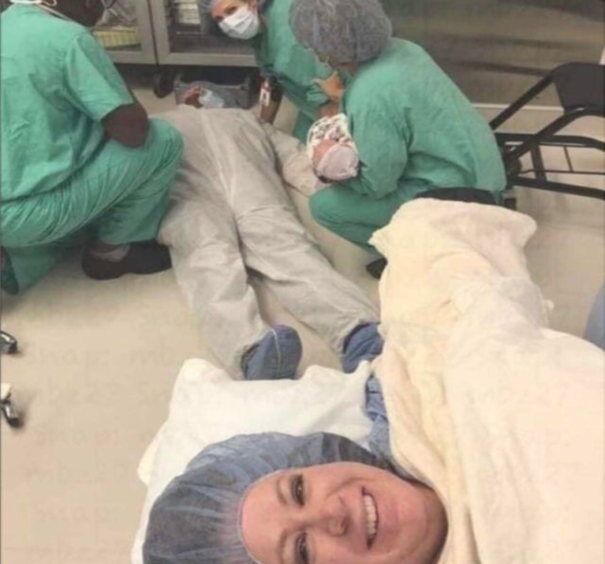 man laying on the floor in delivery room