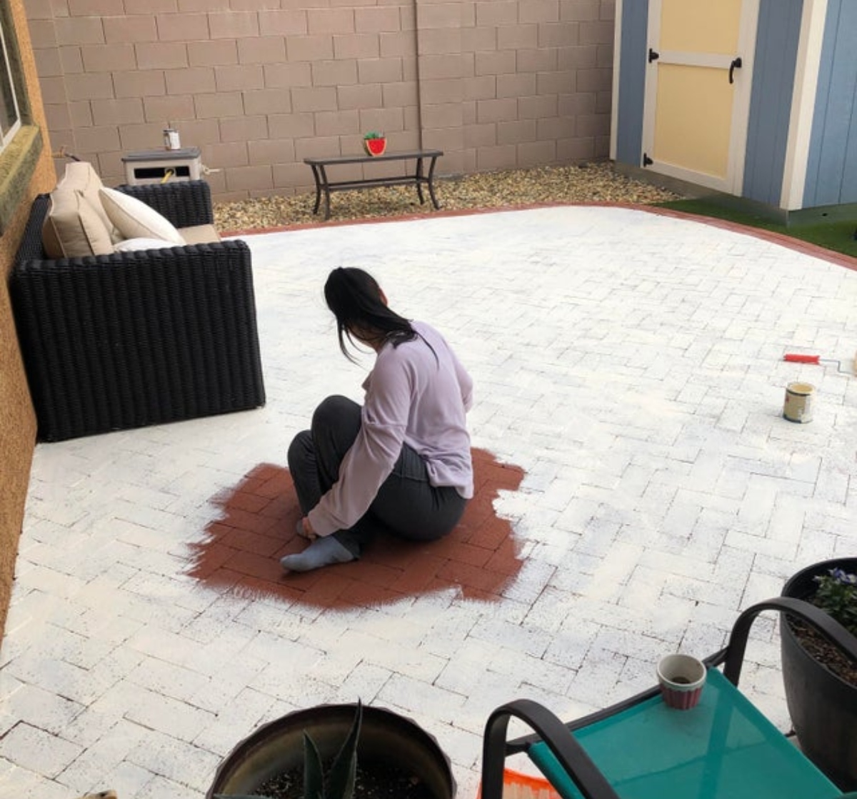 woman painting a patio