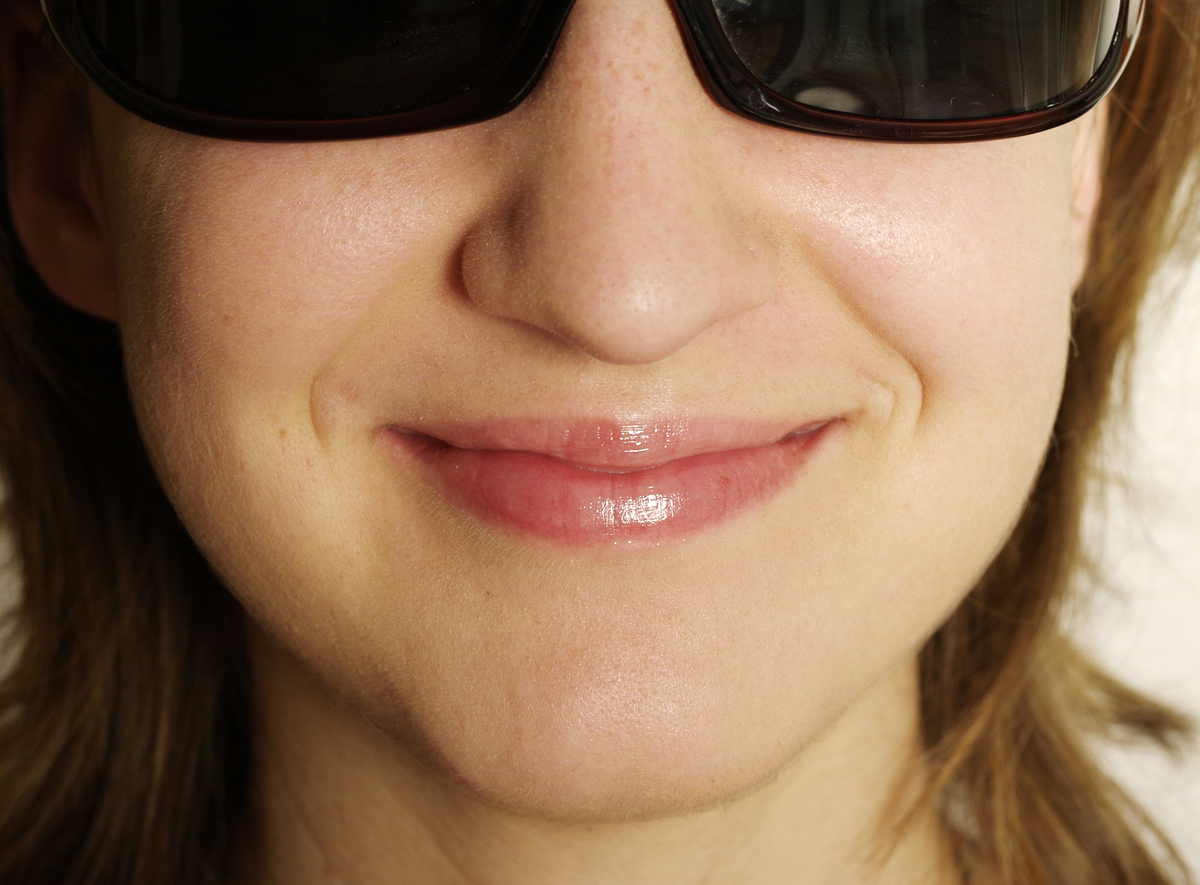 A close-up shows a woman's square-shaped jawline.