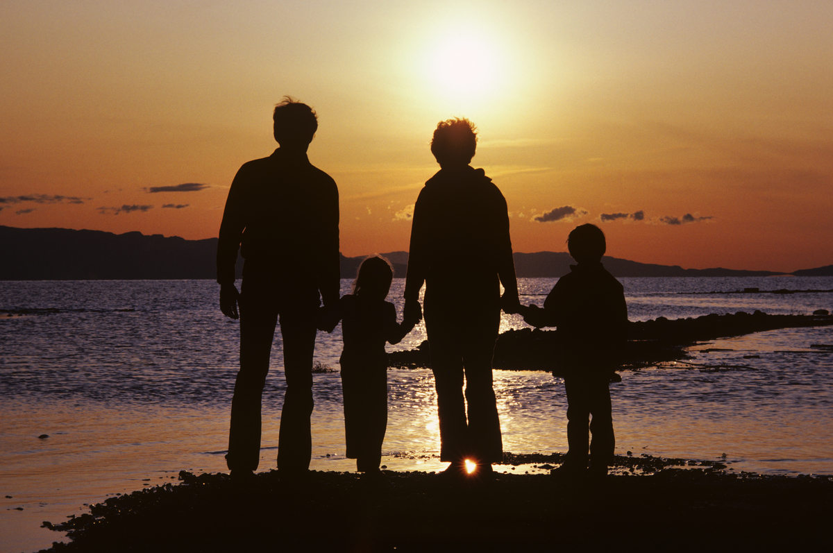 A family watches the sunset together.