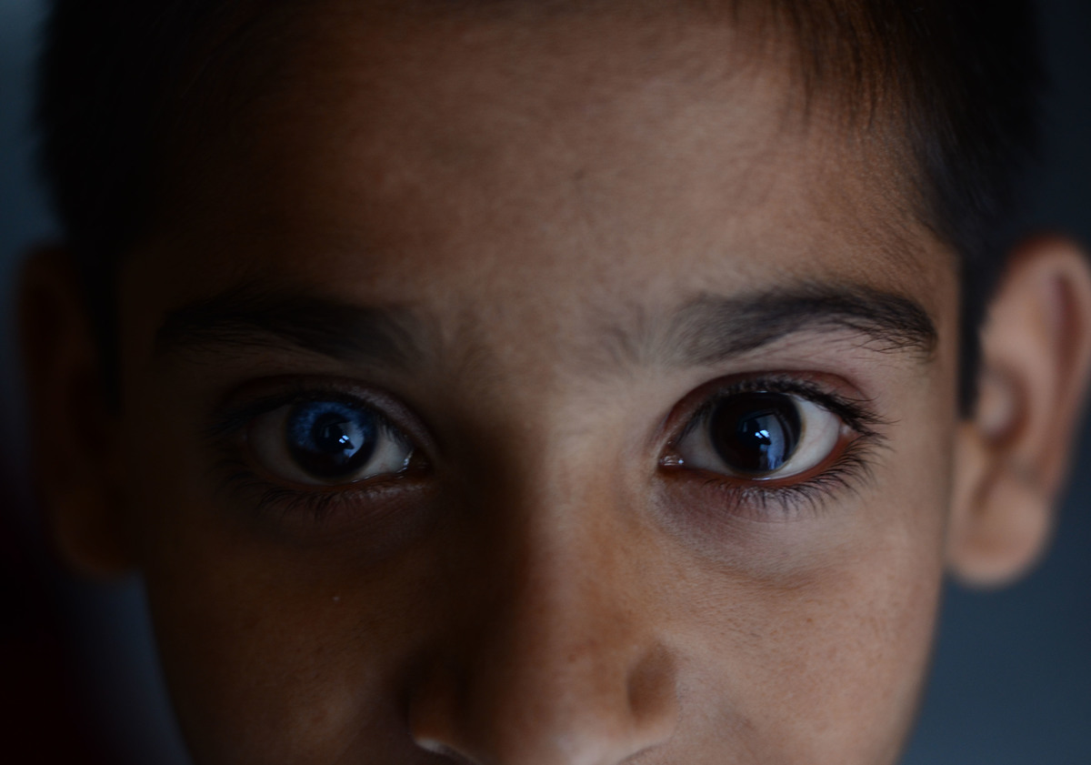 An eleven-year-old stares at the camera.
