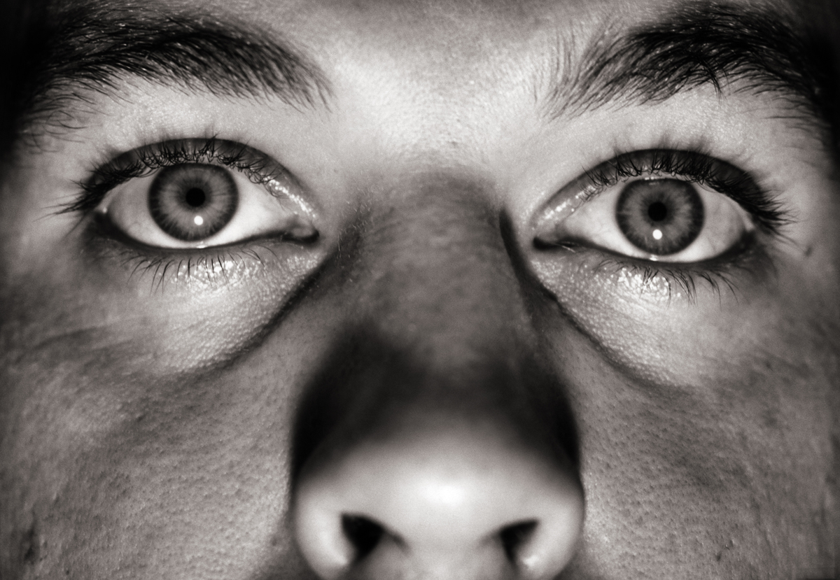 A man's eyes and nose are seen in a close-up.