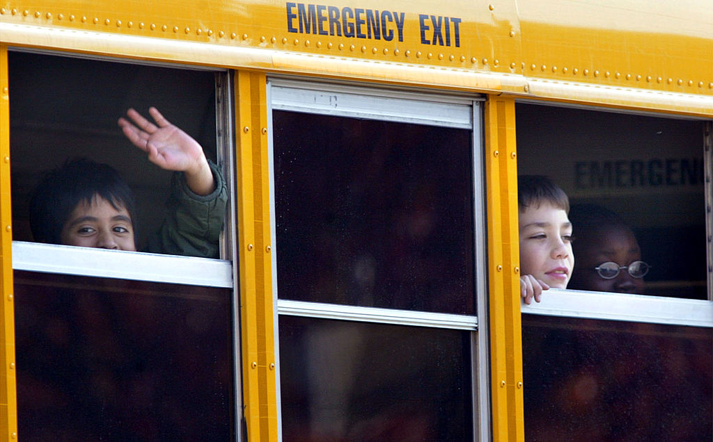 kids waving from the school bus