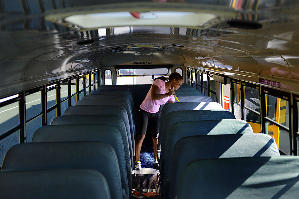 driver cleaning school bus