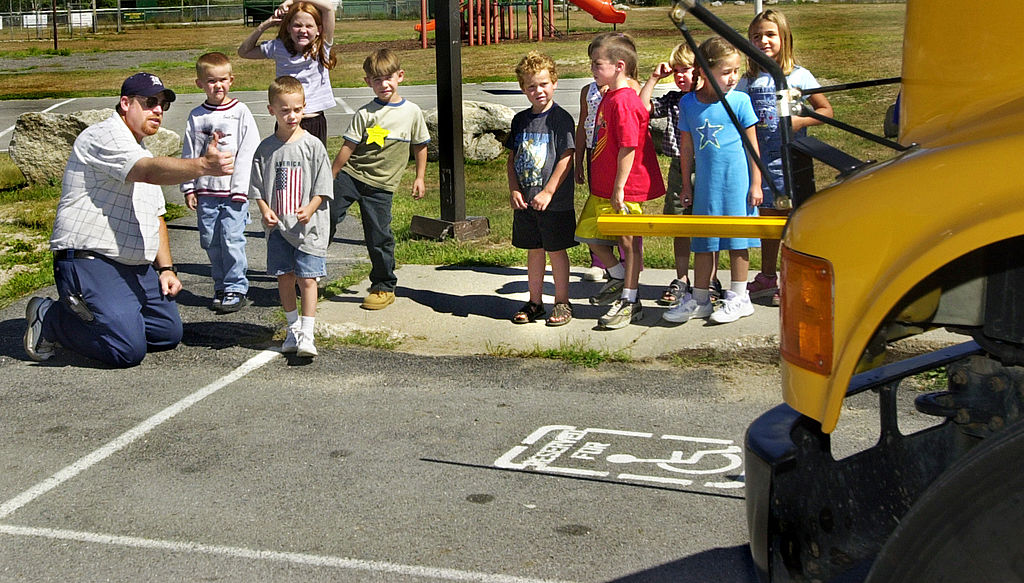 a school bus driver working with students
