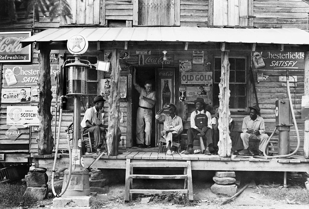 Men sitting in front of store