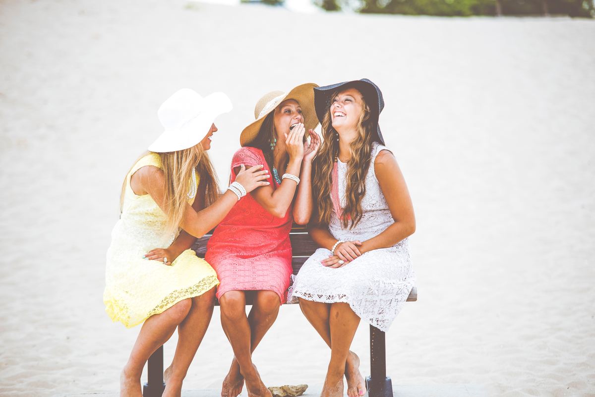 three women on bench at beach