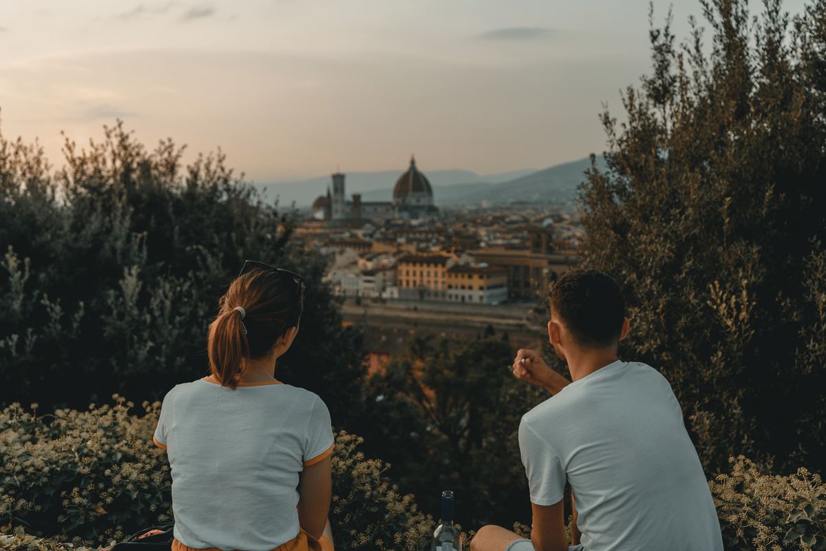 girl and boy sitting together overlooking city