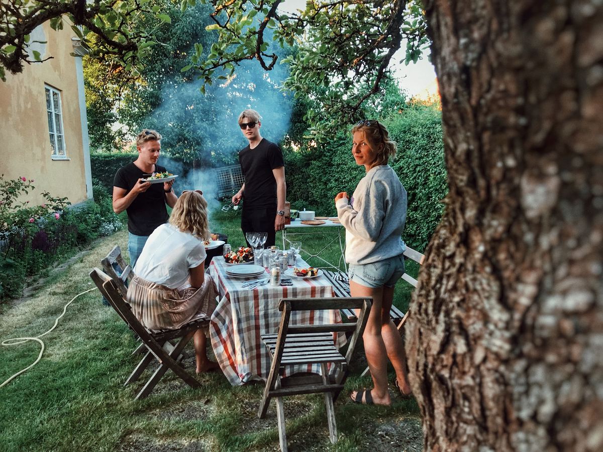 two couples having dinner outdoors