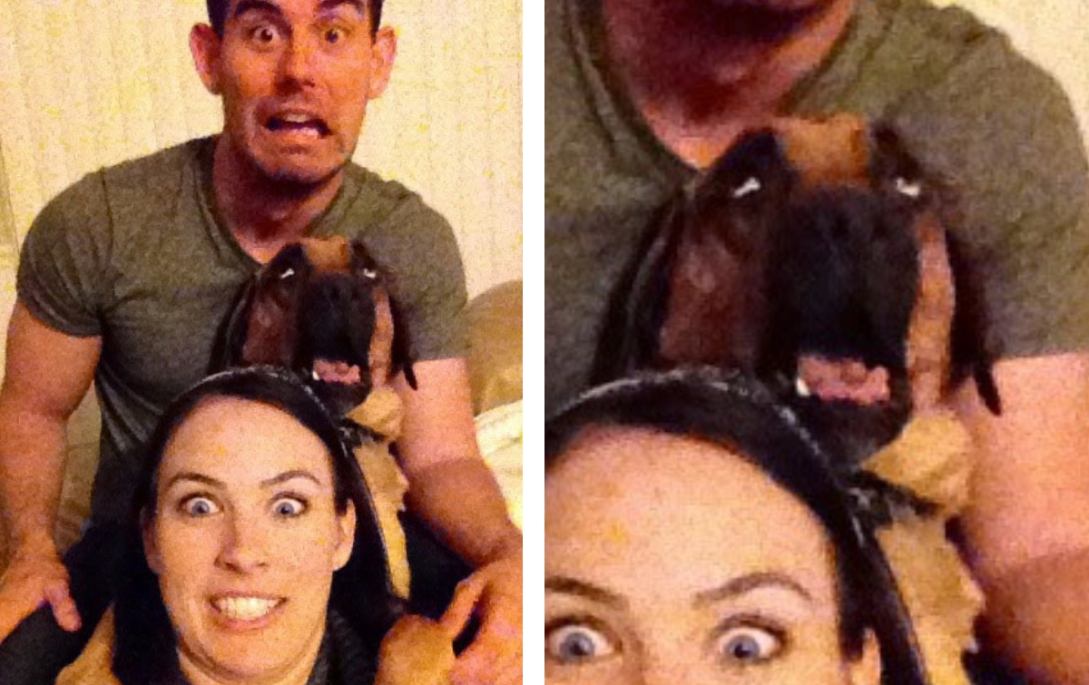 dog yawning in between two people