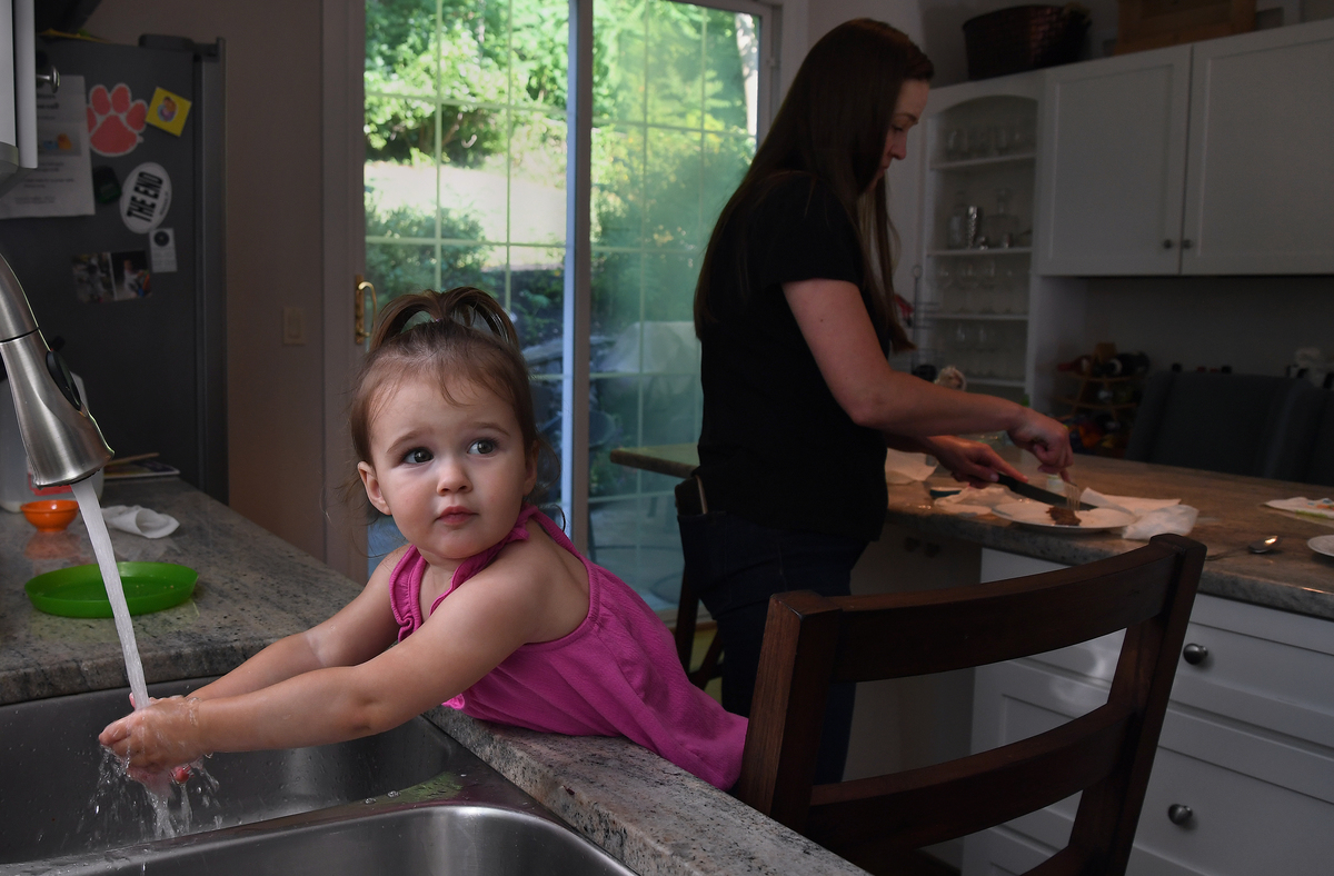 A child washes her hands before dinner.