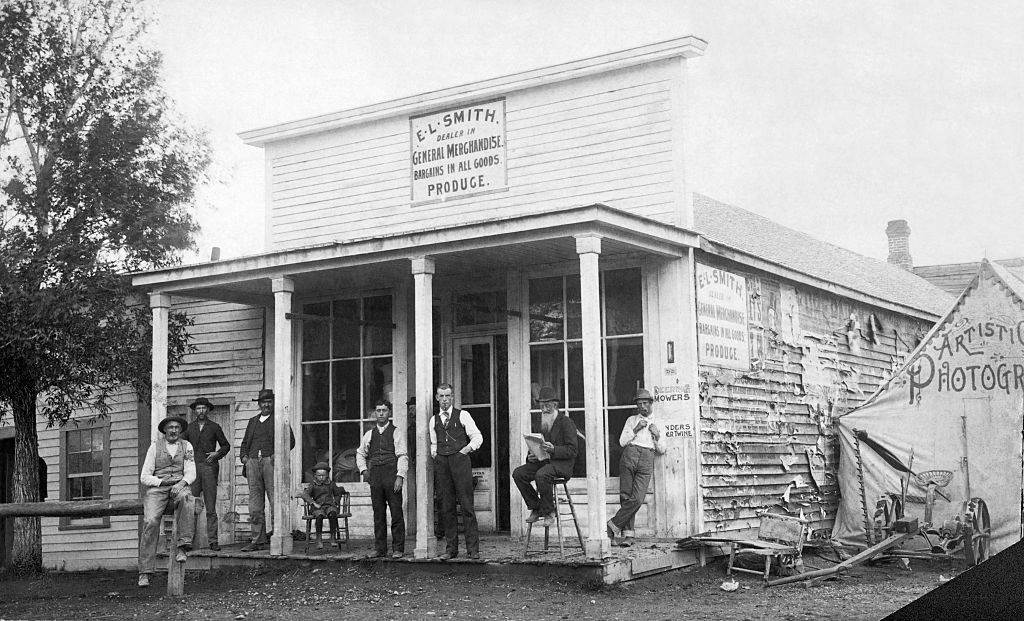 Men standing outside of general store