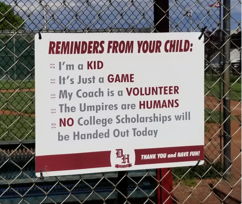 Sign reminds parents not to yell at children, coaches, and umpire at youth baseball park