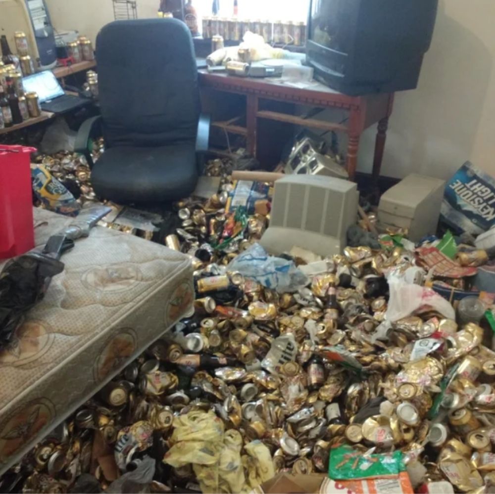 room with entire floor covered in empty beer cans