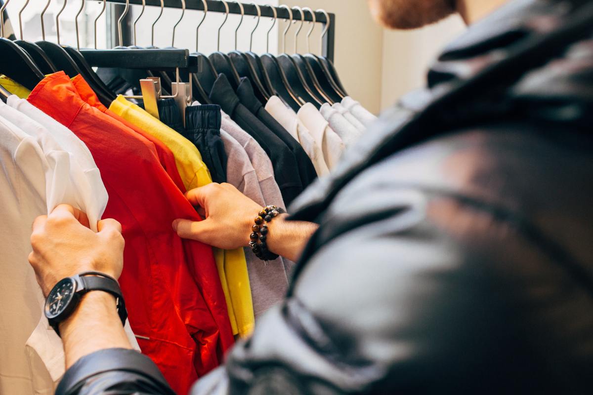 man in leather coat shopping in a store