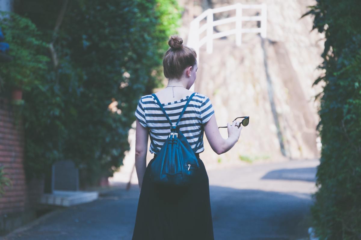 girl in striped tshirt walking alone