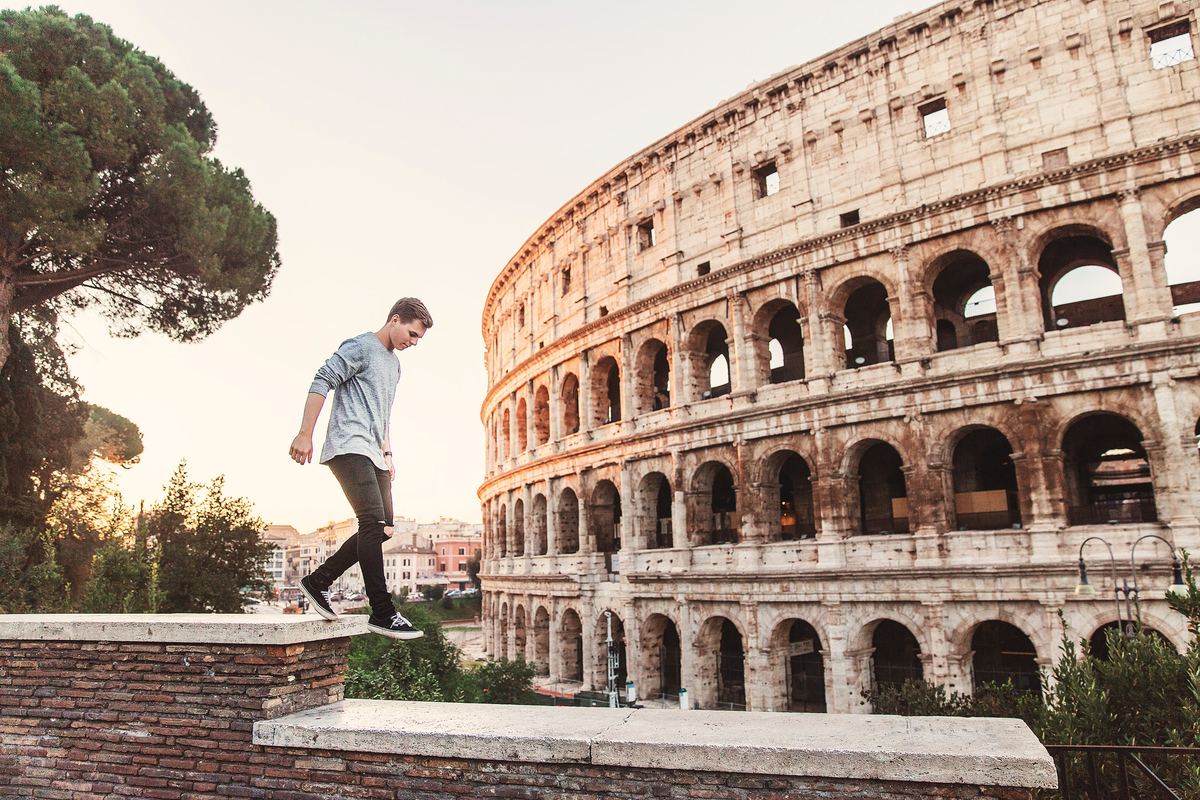 a man walking by an ancient roman site in rome, italy