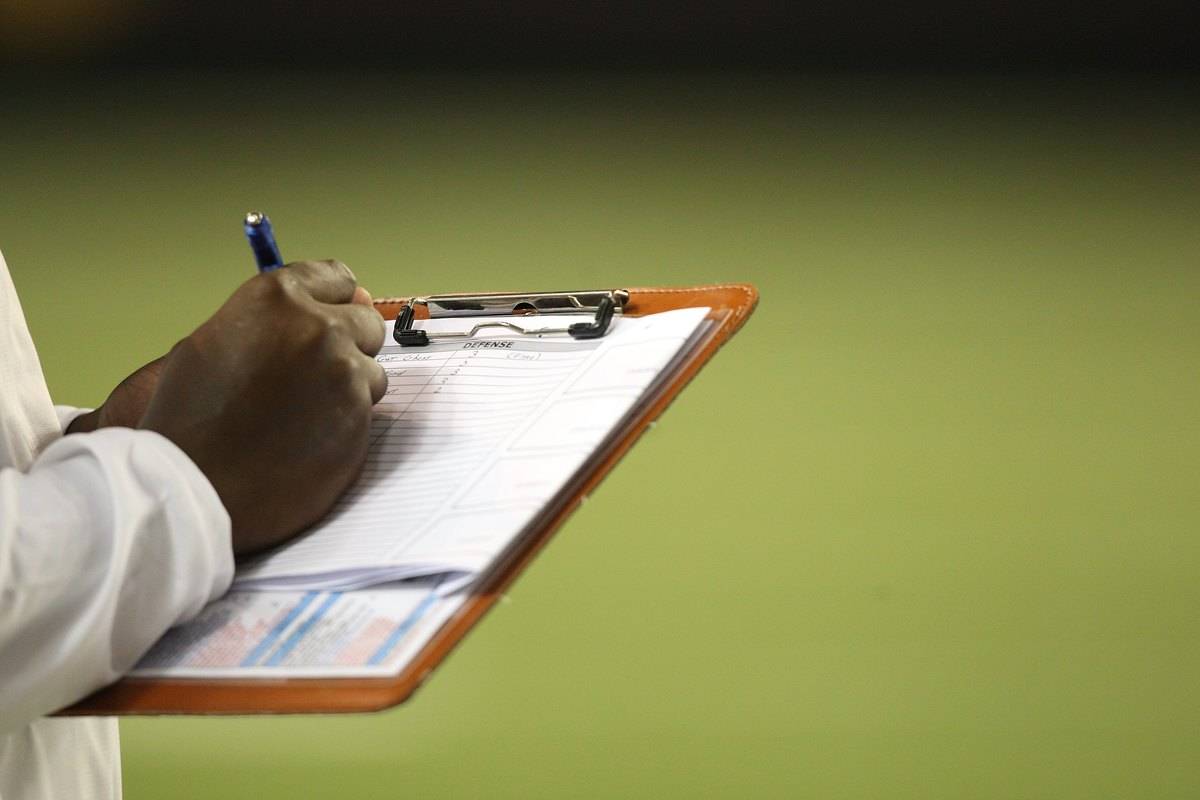 Person going through sheet on clipboard