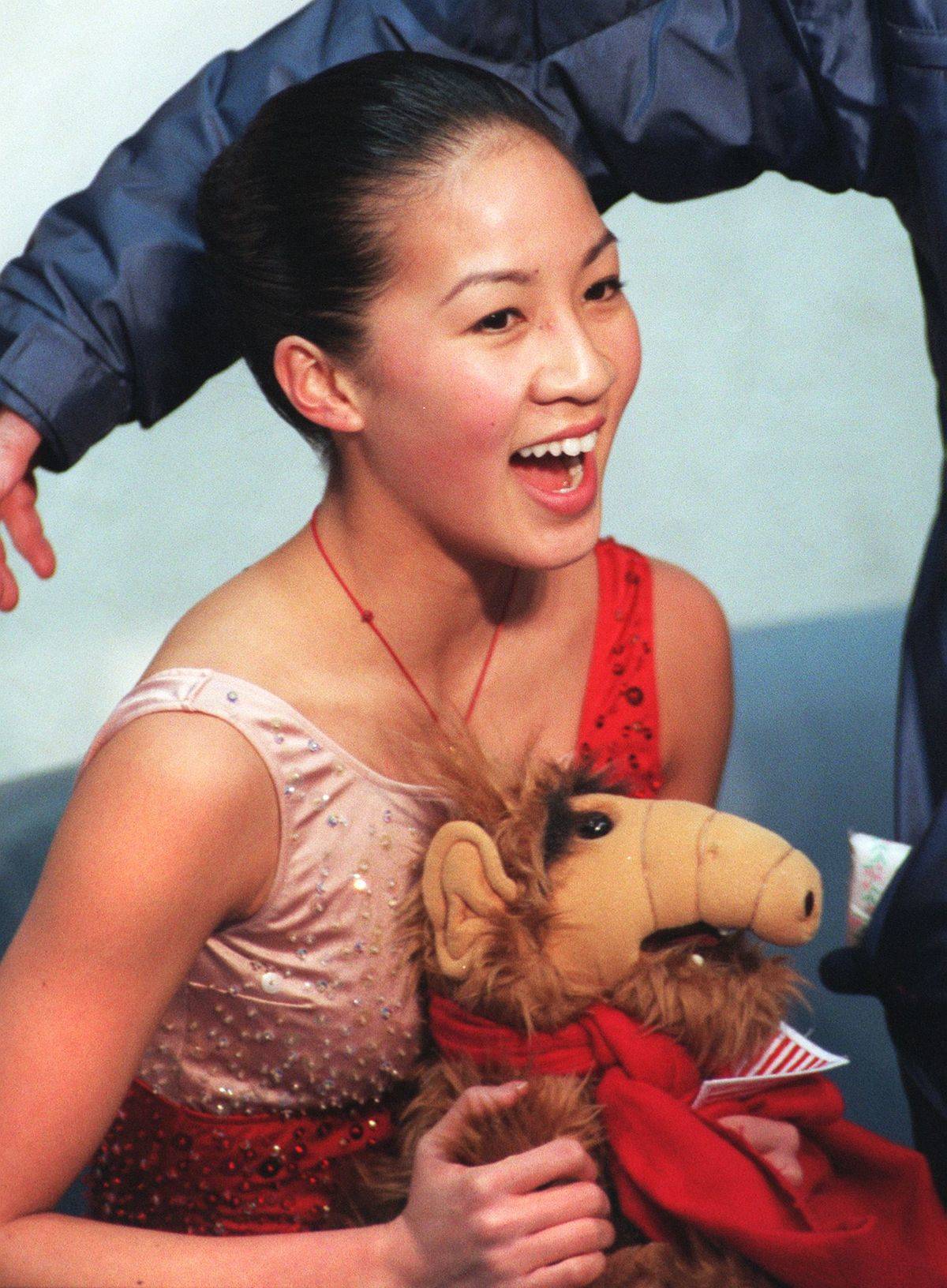 michelle kwan holds and Alf doll