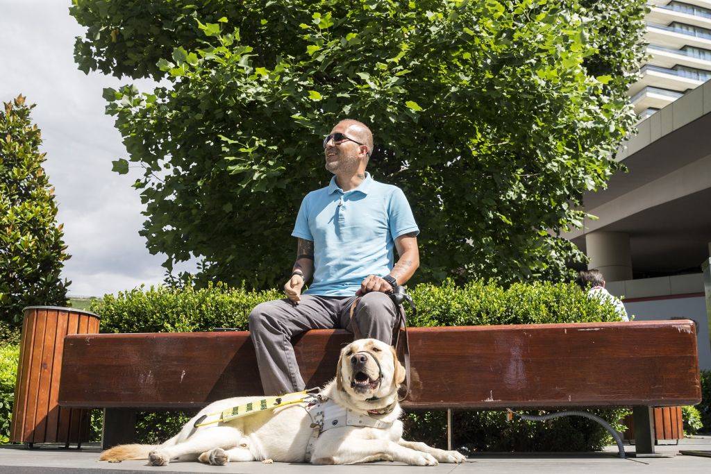 a man sits with his dog