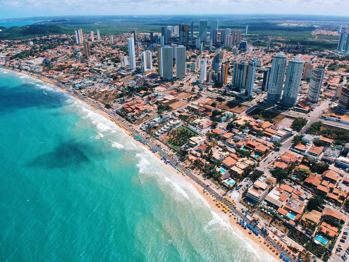 an aerial view of the beach and skyline in Natal, Brazil