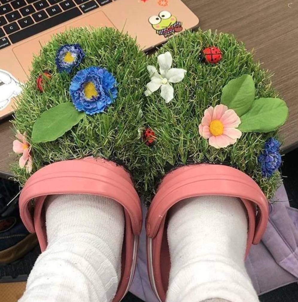crocs with entire top covered in turf with flowers on it