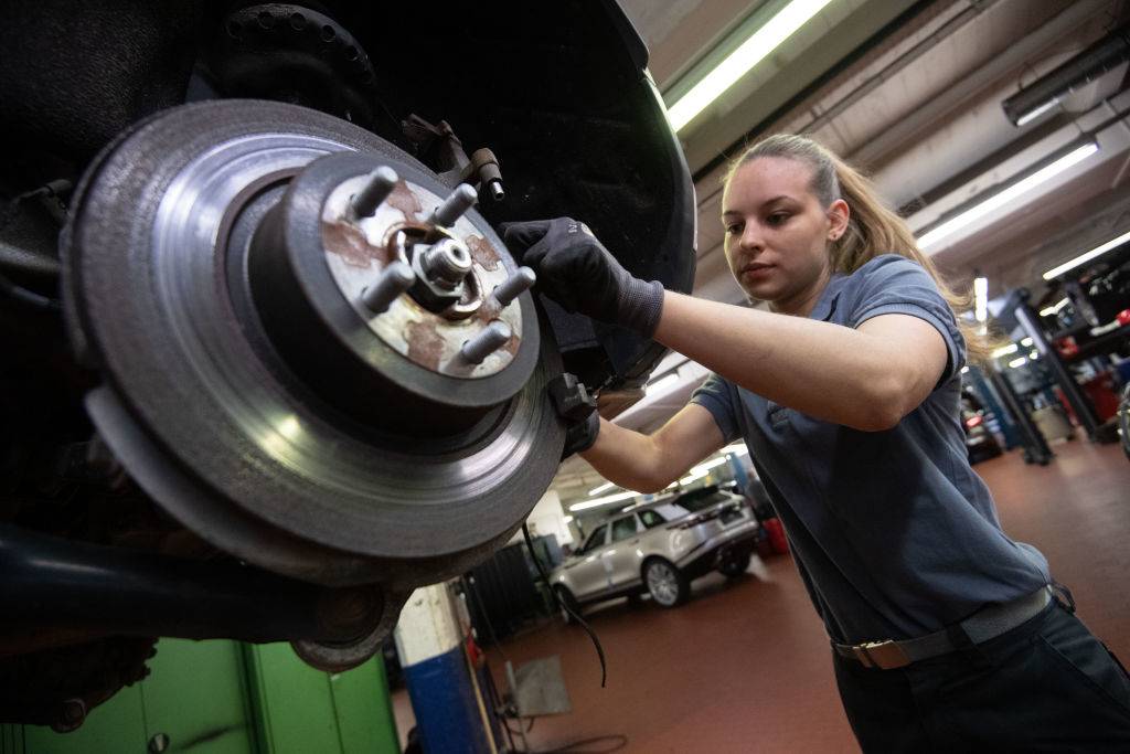 a girl working on a car