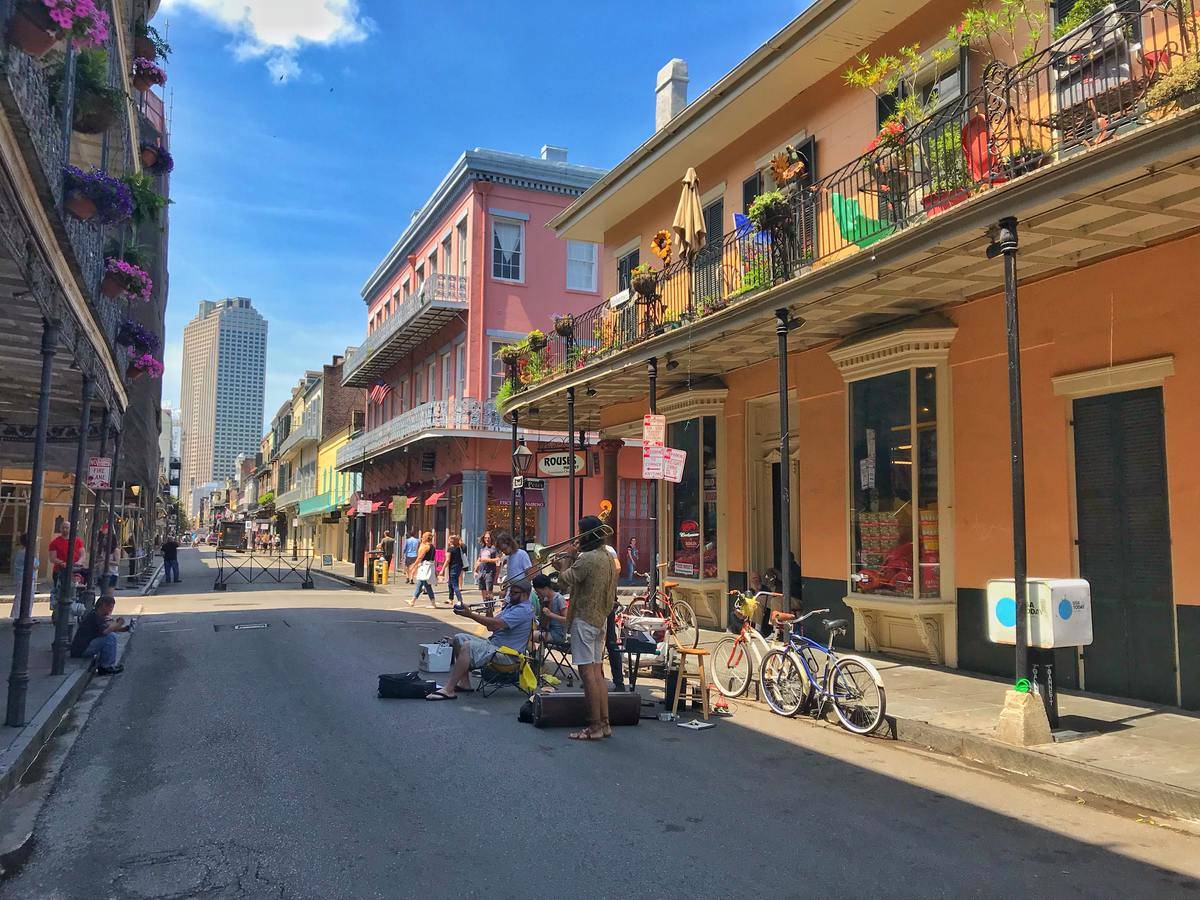 the french quarter of new orleans, louisiana with street performers and bright buildings
