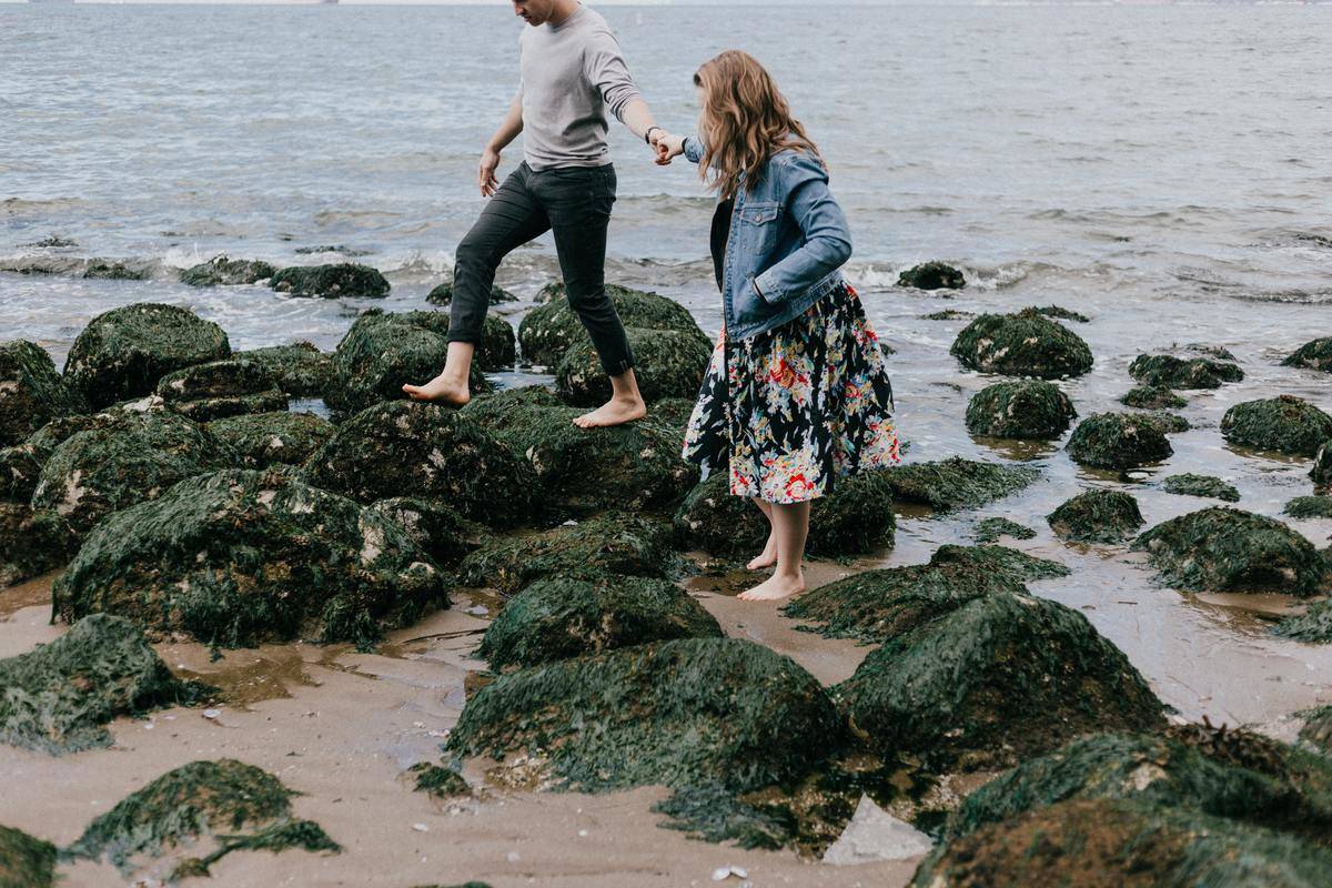 couple walking bare foot on rocks
