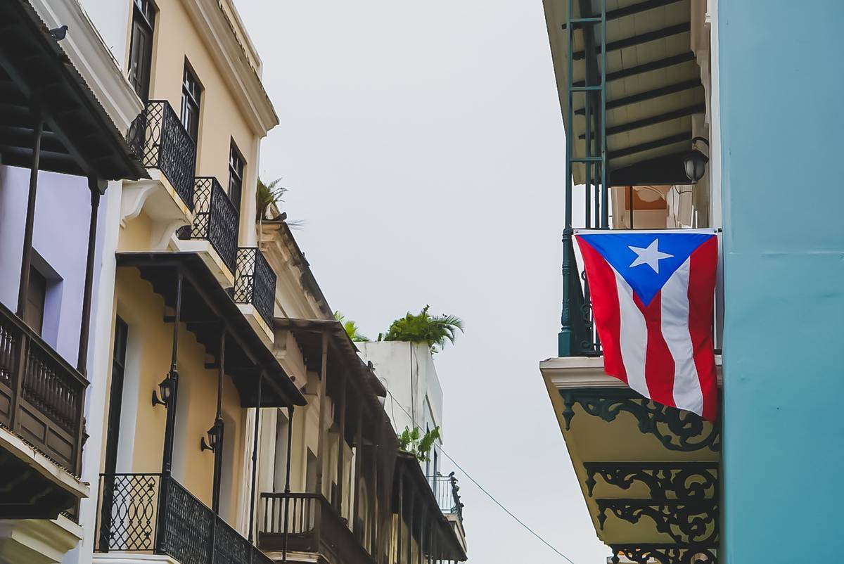 the puerto rican flag hung off a building in san juan, puerto rico