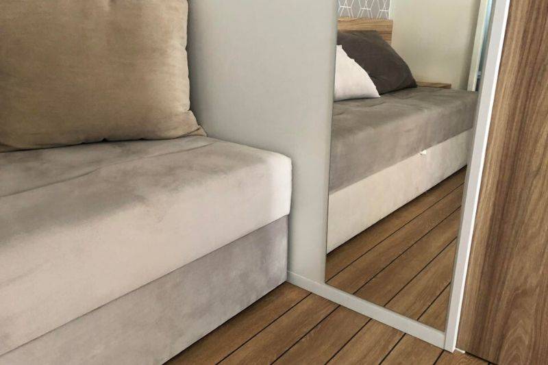 a couch looks different colors in the reflection
