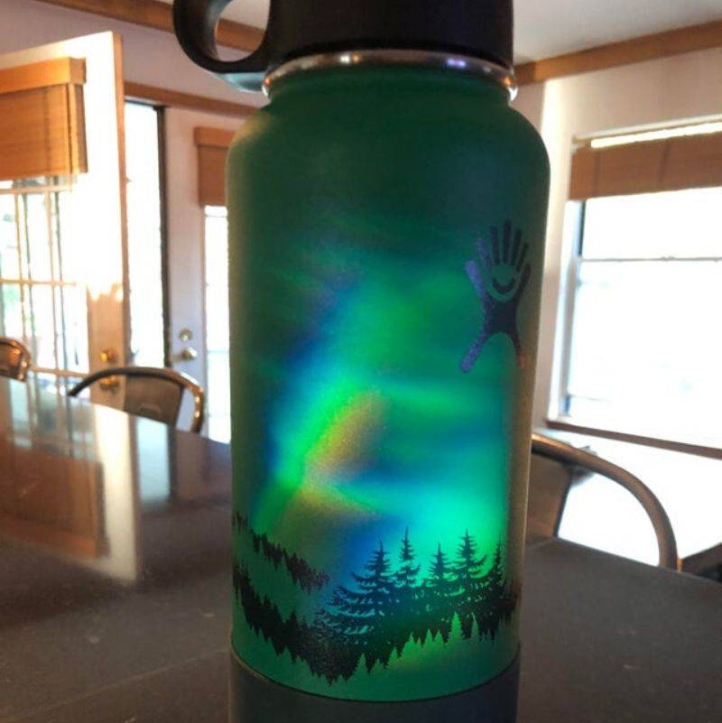 water bottle with a reflection that looks like the northern lights