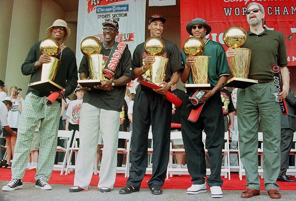 chicago bulls holding championship trophies