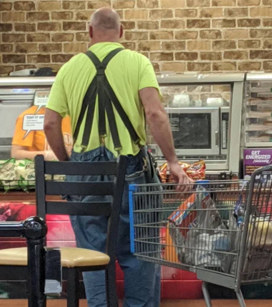 man wears suspenders with five clips on the back to hold pants up