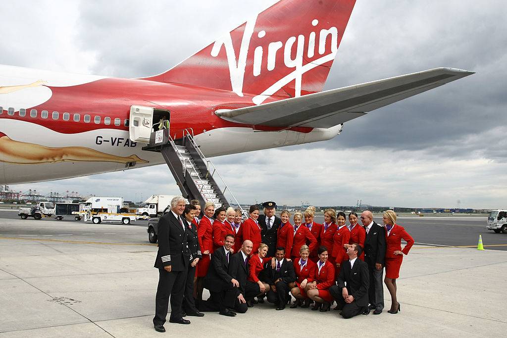Sir Richard Branson (center) and crew members of flight VS001 pose for a photograph