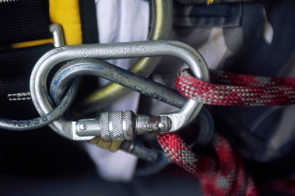 a metal carabiner clip with rope