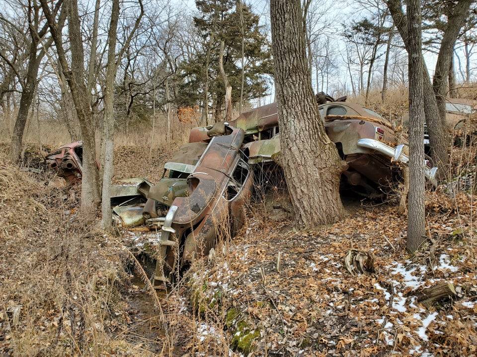 a bunch of abandoned cars 