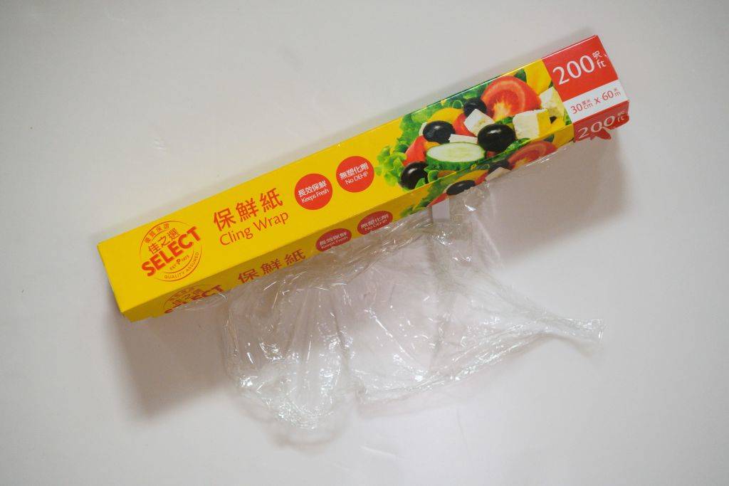 a box of cling wrap with the plastic sticking out