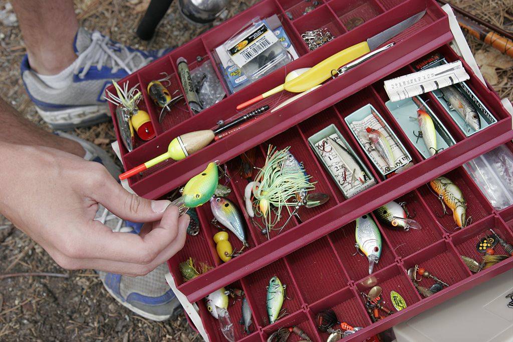 a red bait and tackle box with fishing equipment