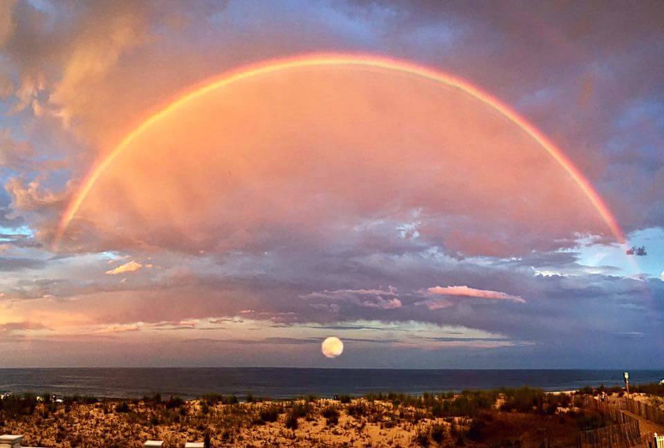 rainbow over the setting sun