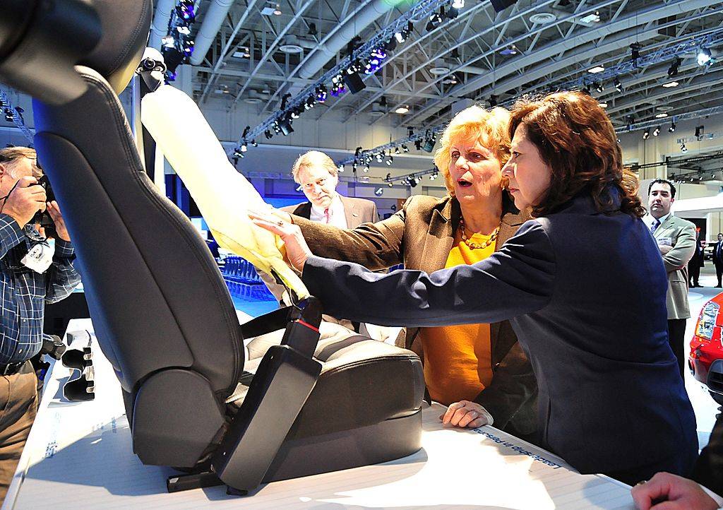 people touching an inflatable seat belt