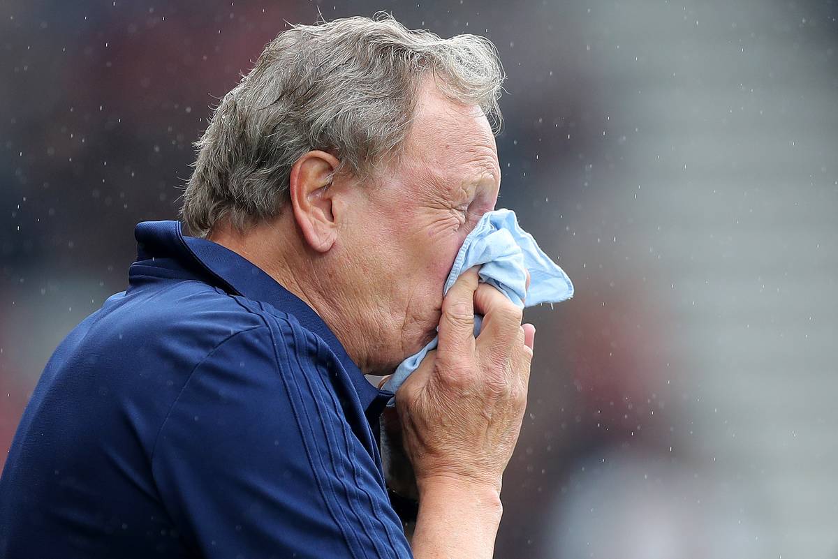 Cardiff manager Neil Warnock blows his nose.