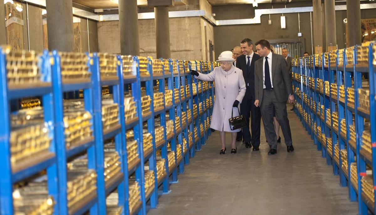 Queen Elizabeth II views stacks of gold as she visits the Bank of England