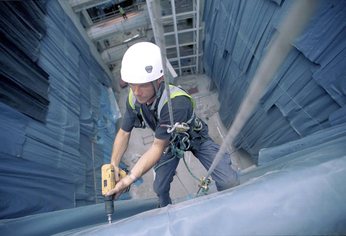 Construction worker abseiling