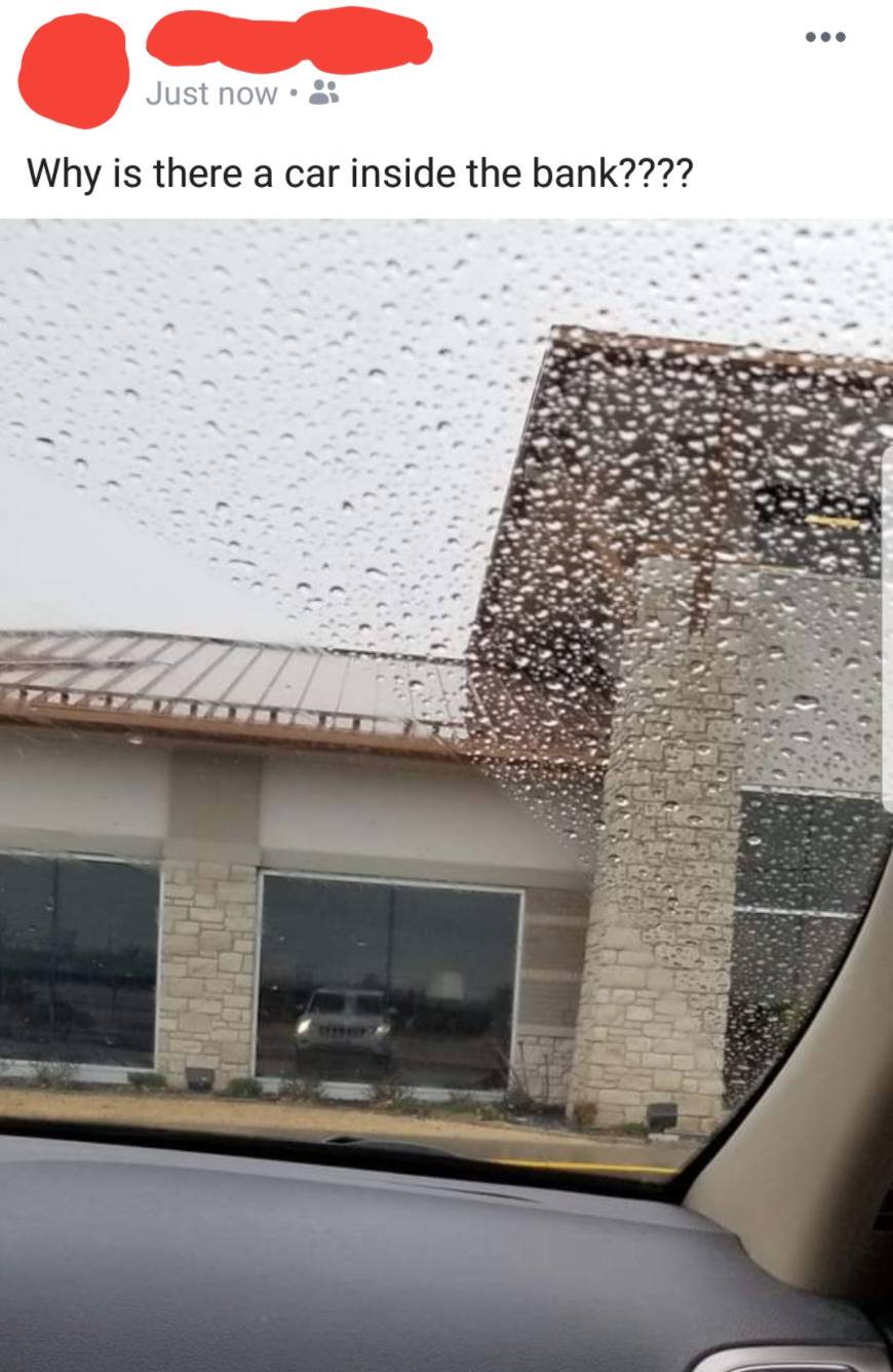 person posts photo asking why there is a car inside the bank, but it's just the reflection of their car on the windows