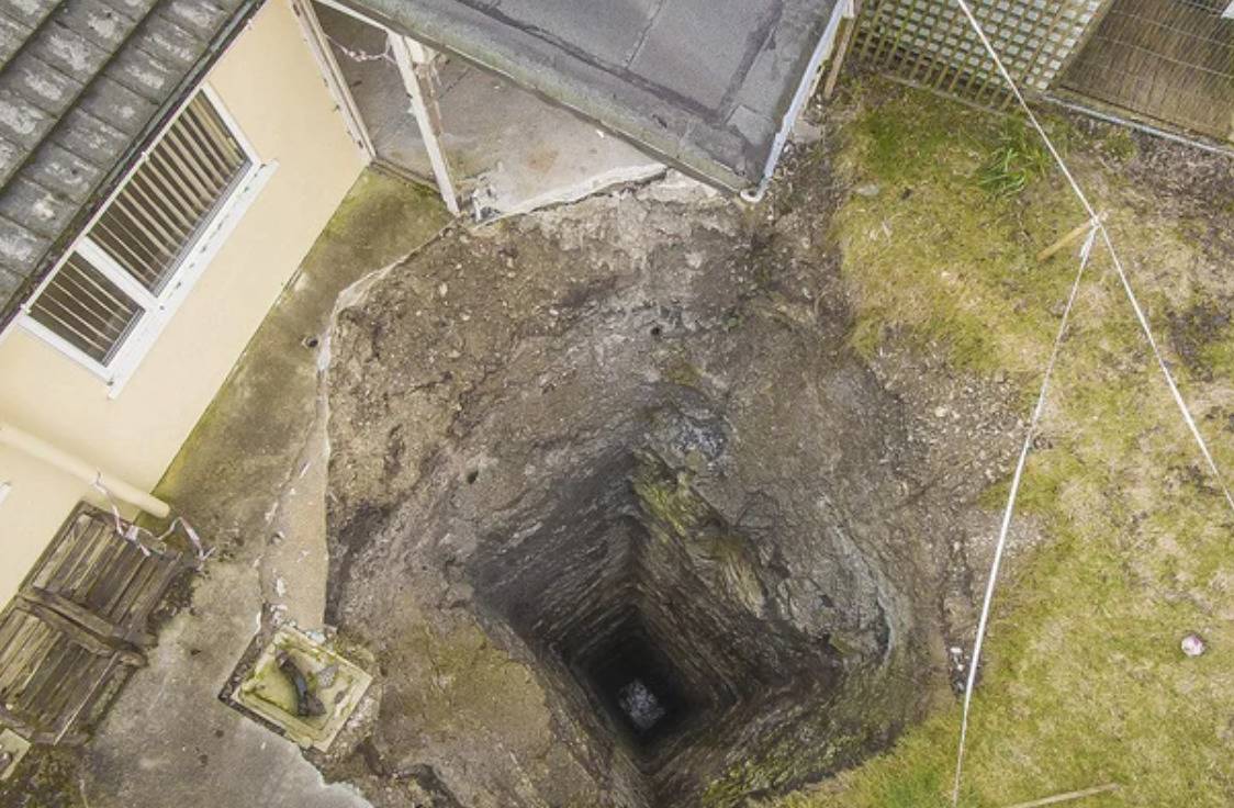 square shaped hole in ground goes hundreds of feet deep