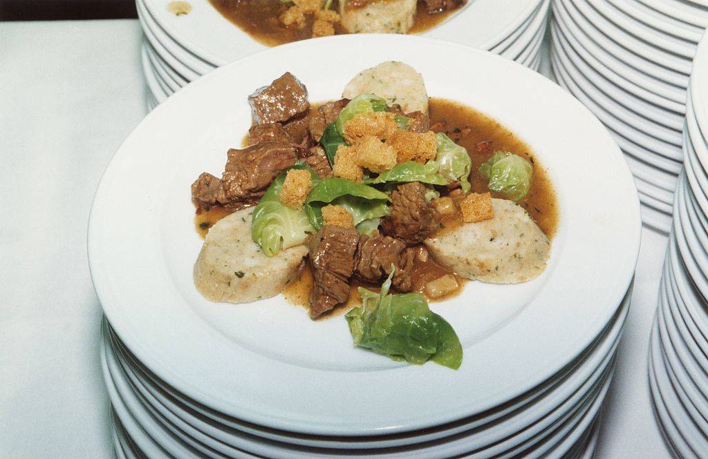 goulash with meat, lettuce, croutons, and potatoes