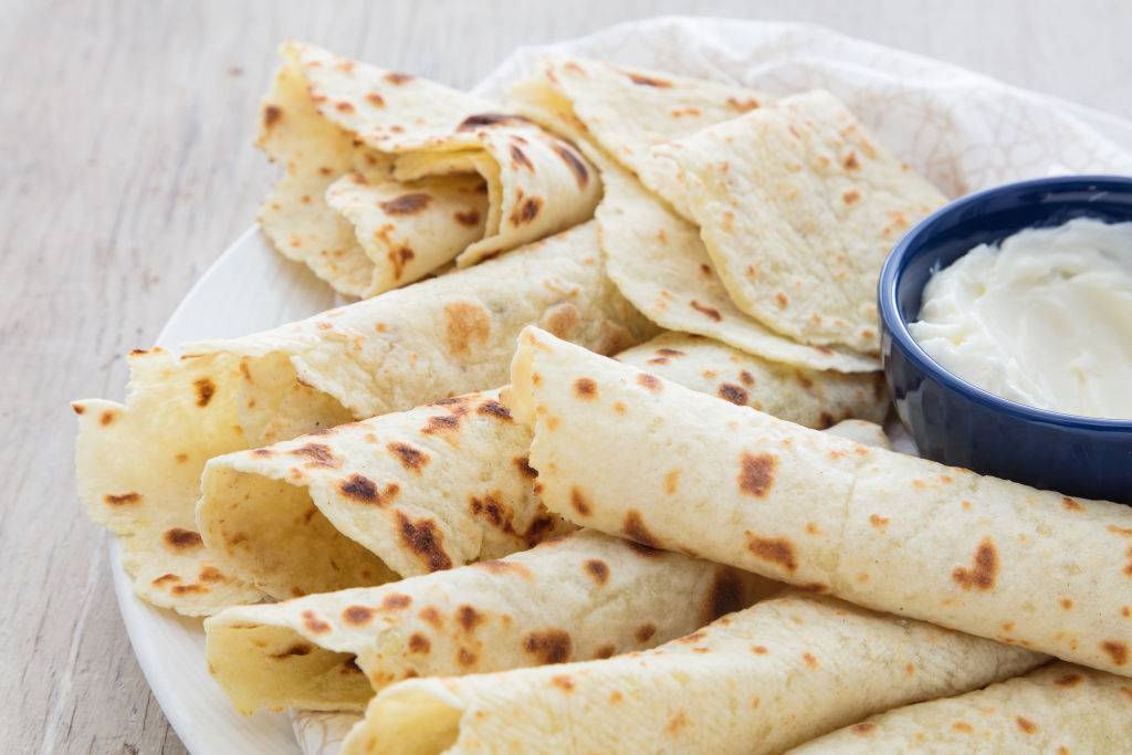Rolled Lefse with a dip on a oval plate