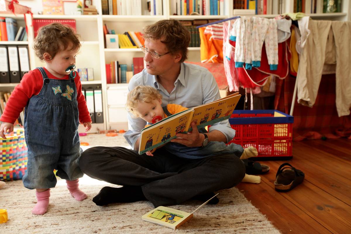dad reads to his twin 14-month-old daughters