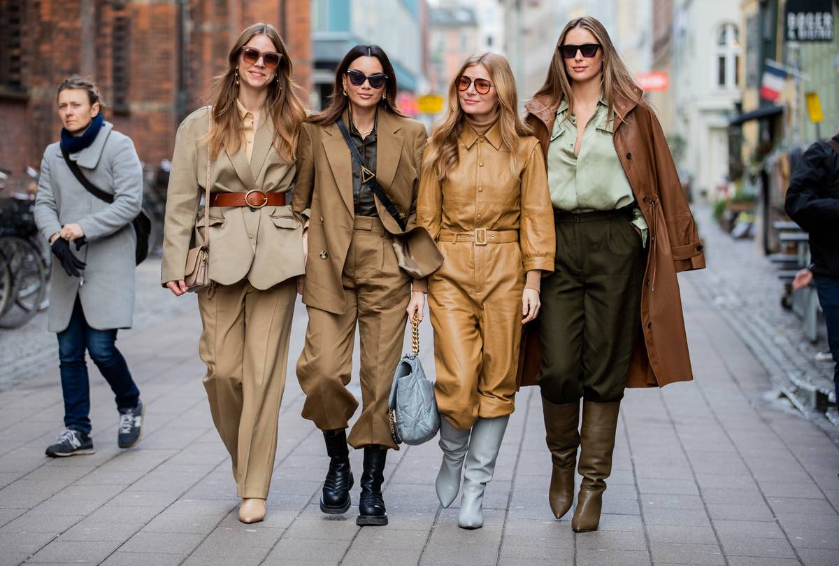 women in fashionable outfits walking on copenhagen sidewalk